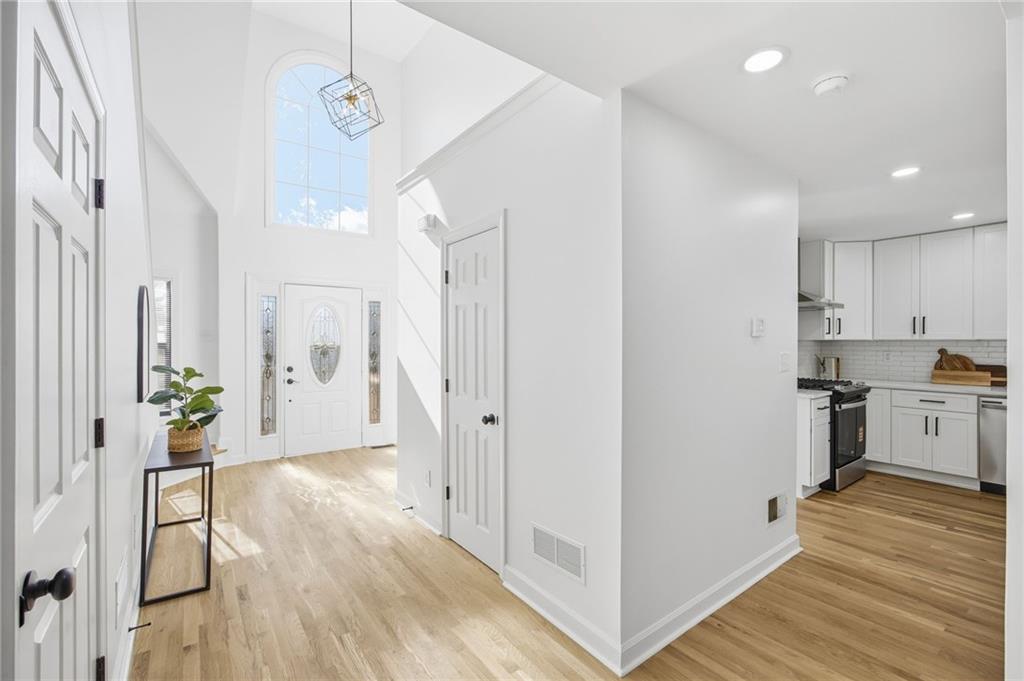 68 Winward Way Southeast Smyrna, GA 30082 - Photo 4 of 42 a view of a hallway with wooden floor and a living room
