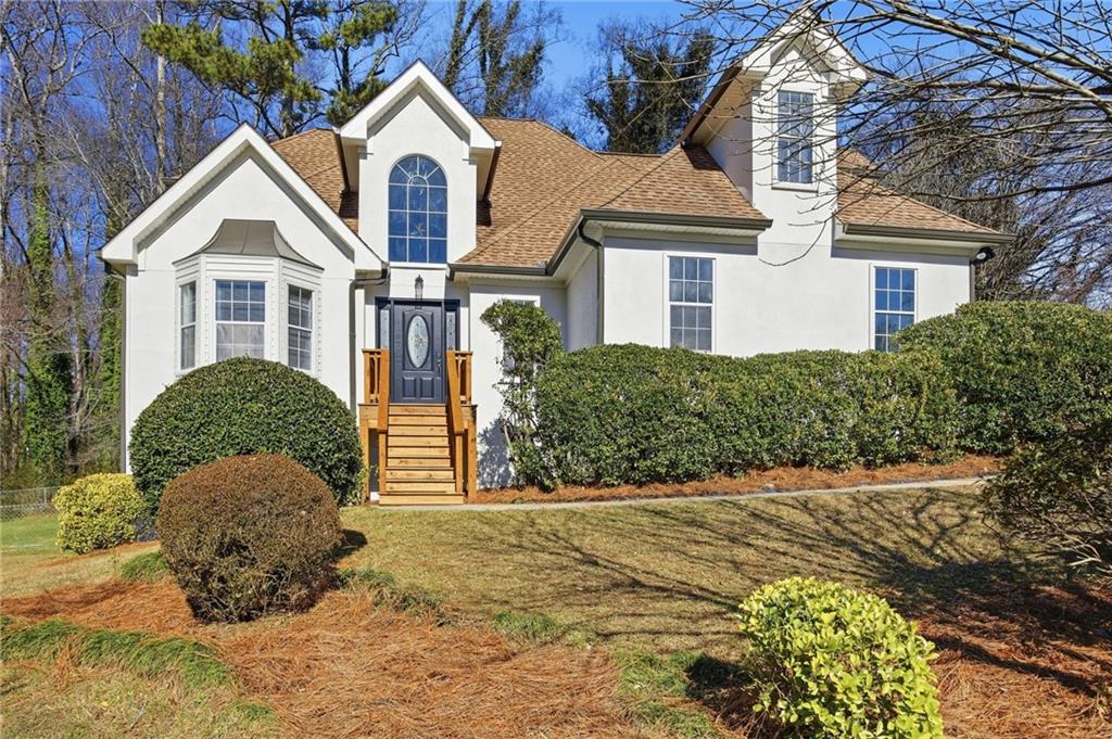 68 Winward Way Southeast Smyrna, GA 30082 - Photo 42 of 42 a front view of a house with a yard and garage