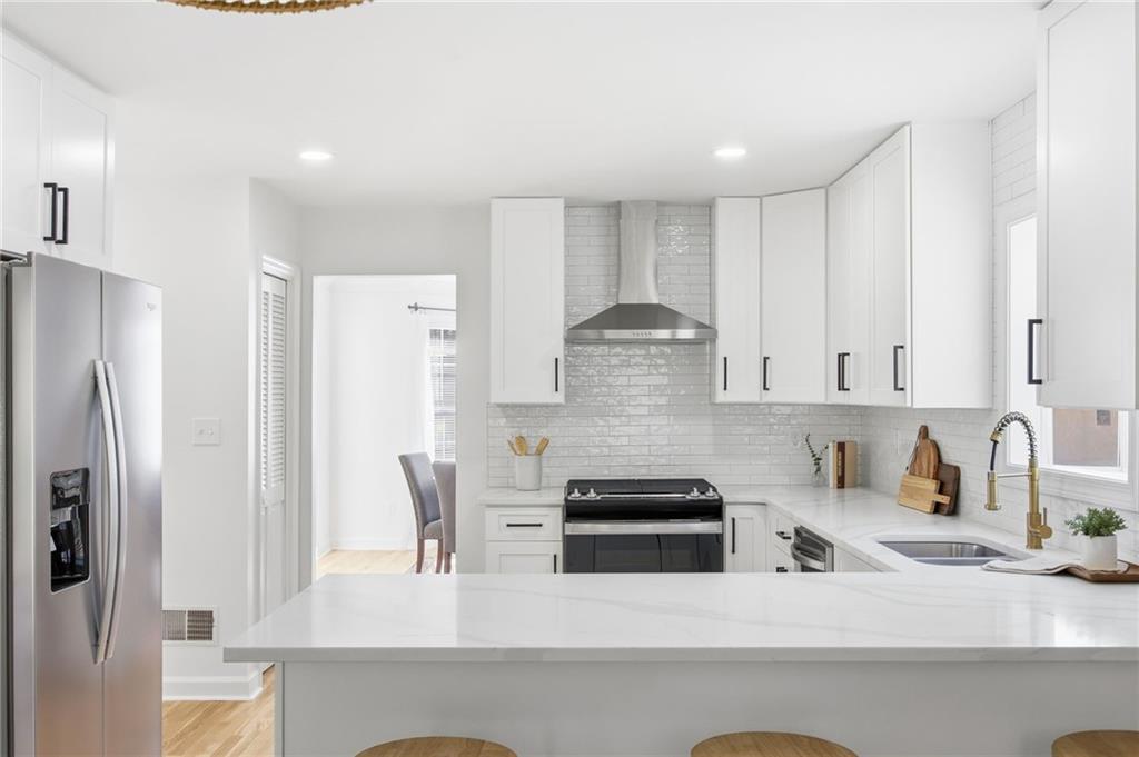 68 Winward Way Southeast Smyrna, GA 30082 - Photo 8 of 42 a kitchen with stainless steel appliances a refrigerator sink and white cabinets