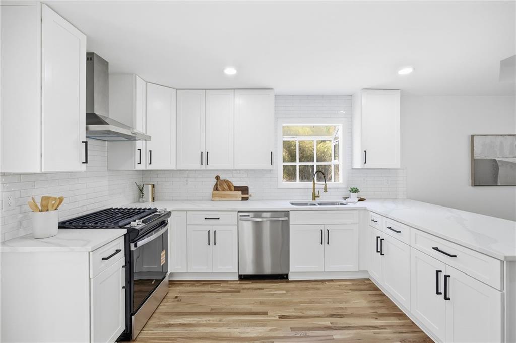 68 Winward Way Southeast Smyrna, GA 30082 - Photo 9 of 42 a kitchen with granite countertop white cabinets and white appliances