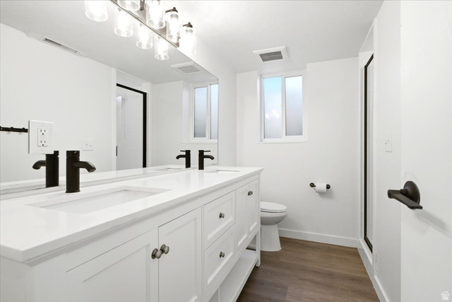 1676 East 11245 South Sandy, UT 84092 - Photo 19 of 34 Double vanity with integrated sinks, matte black faucets, and brushed nickel hardware