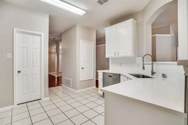 a kitchen with a sink and a refrigerator