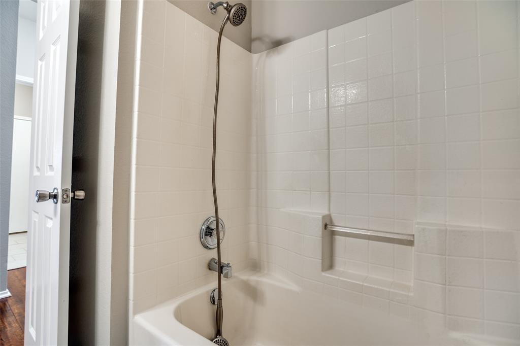 8308 Ram Ridge Road Fort Worth, TX 76137 - Photo 22 of 24 a bathroom with a tub and a shower