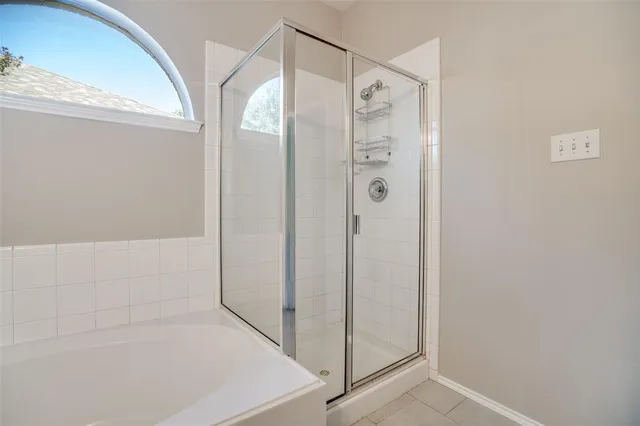 a bathroom with a shower and a glass door