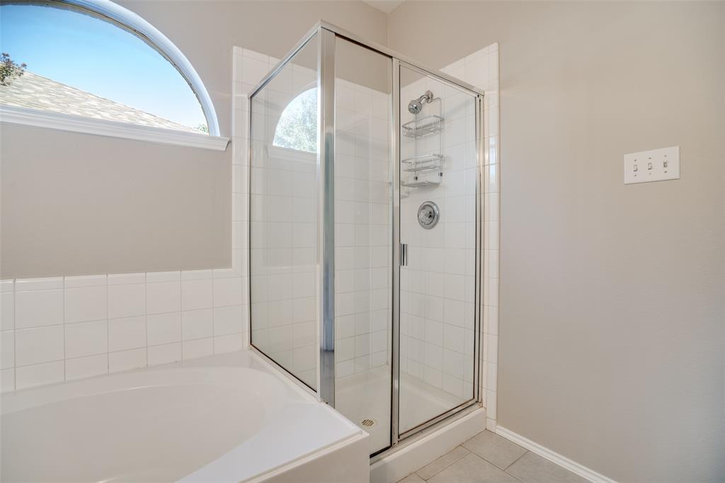 8308 Ram Ridge Road Fort Worth, TX 76137 - Photo 7 of 24 a bathroom with a shower and a glass door