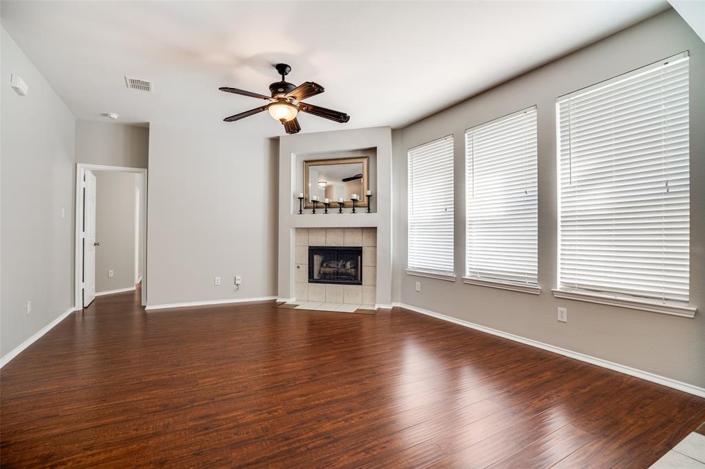 8308 Ram Ridge Road Fort Worth, TX 76137 - Photo 9 of 24 a view of an empty room with wooden floor and a window