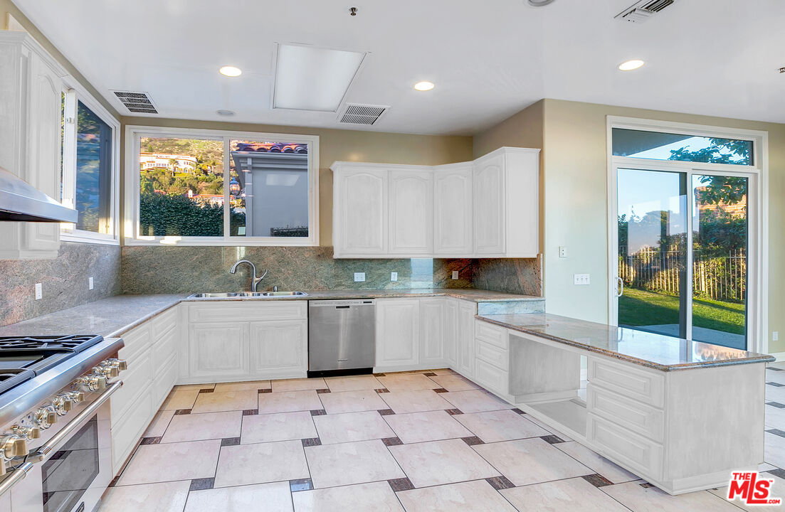 4237 Avenida De La Encinal Malibu, CA 90265 - Photo 14 of 24 a kitchen with a sink window and cabinets