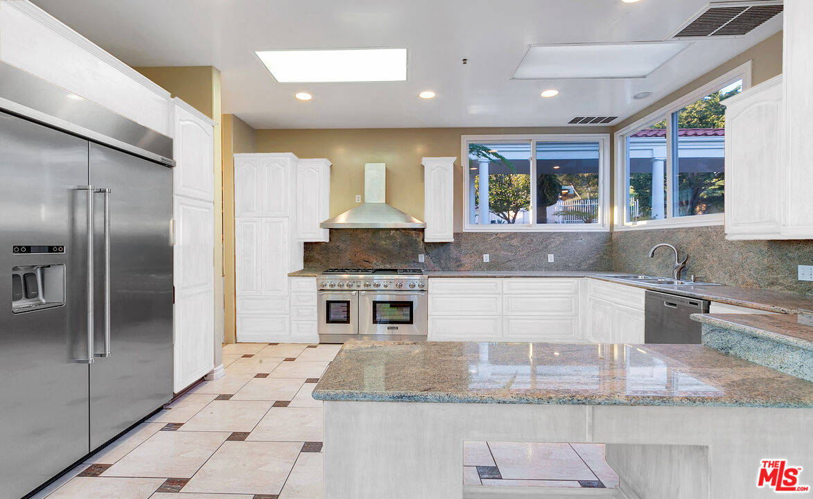 4237 Avenida De La Encinal Malibu, CA 90265 - Photo 15 of 24 a kitchen with stainless steel appliances granite countertop a sink stove and refrigerator