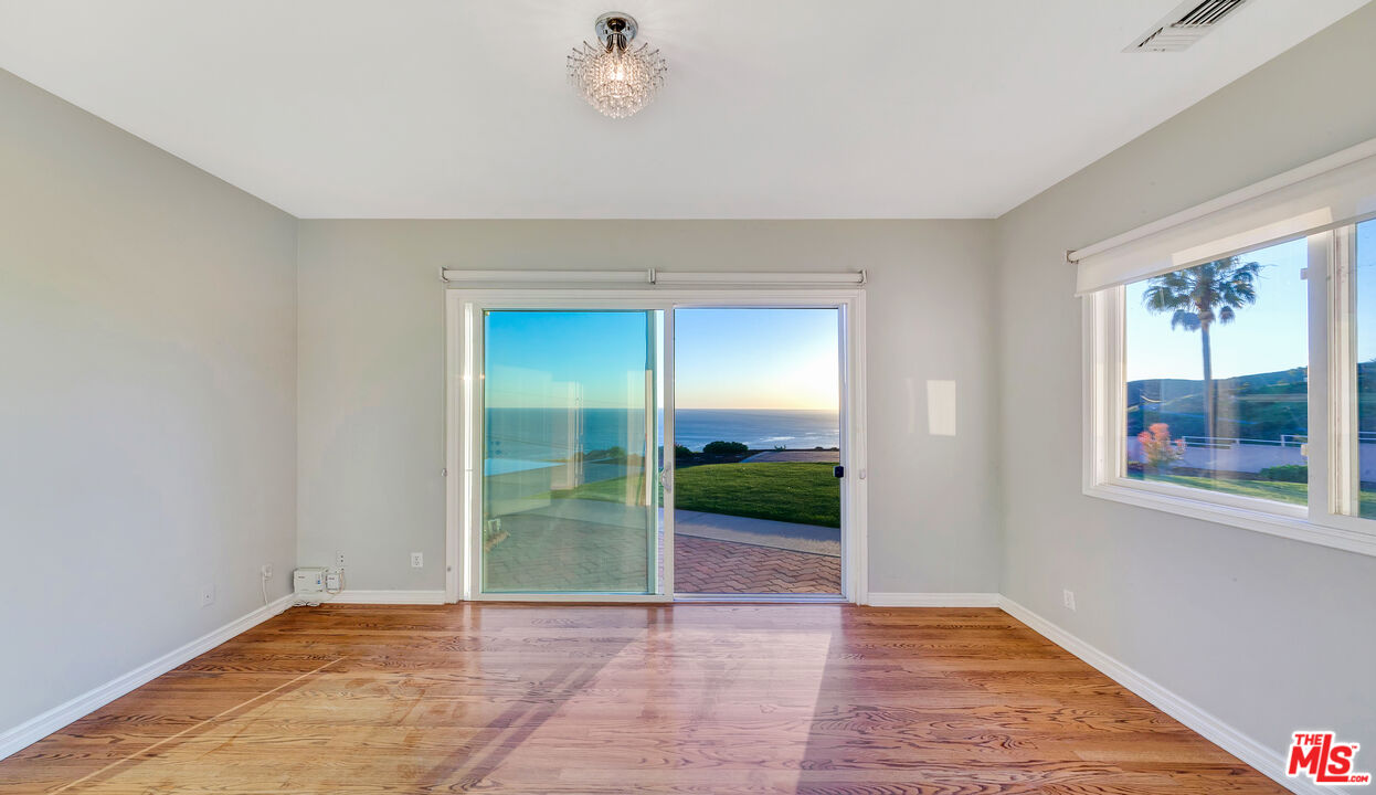 4237 Avenida De La Encinal Malibu, CA 90265 - Photo 20 of 24 a view of an empty room with window and wooden floor