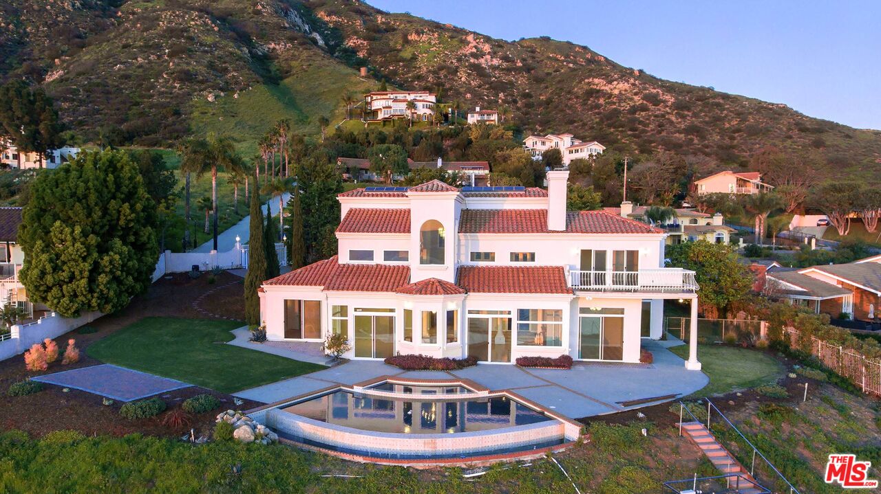 4237 Avenida De La Encinal Malibu, CA 90265 - Photo 22 of 24 a front view of a house with yard swimming pool and outdoor seating