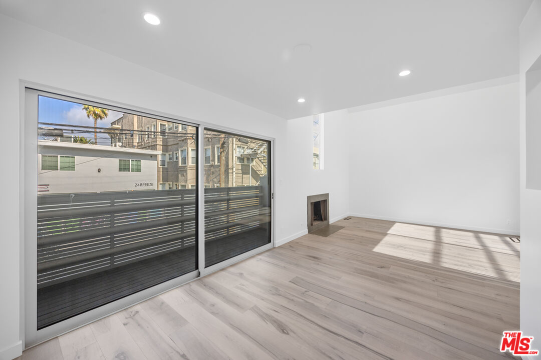 21 1/2 Wavecrest Avenue Venice, CA 90291 - Photo 11 of 29 a view of an empty room with wooden floor and a window