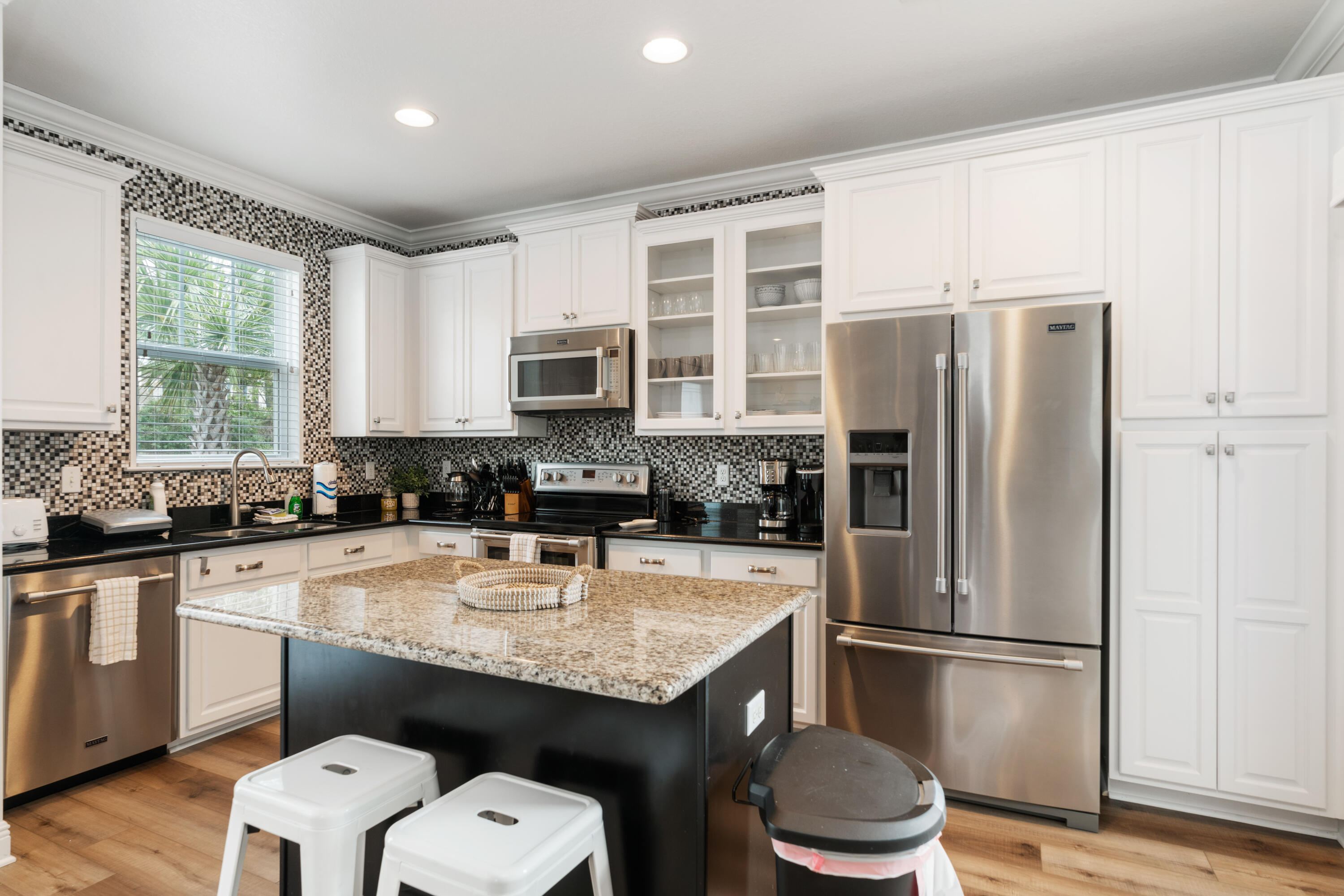 104 Sandpine Loop Inlet Beach, FL 32461 - Photo 7 of 26 a kitchen with a refrigerator a sink dishwasher and white cabinets with wooden floor