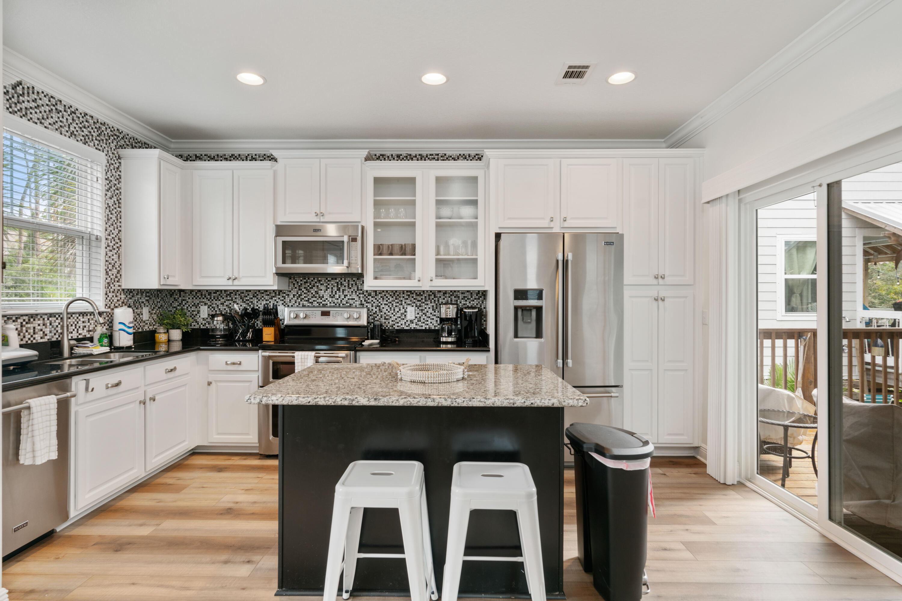 104 Sandpine Loop Inlet Beach, FL 32461 - Photo 9 of 26 a large kitchen with stainless steel appliances granite countertop a stove a sink dishwasher a microwave oven and a refrigerator with wooden floor