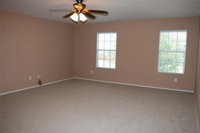 a view of an empty room with a fan
