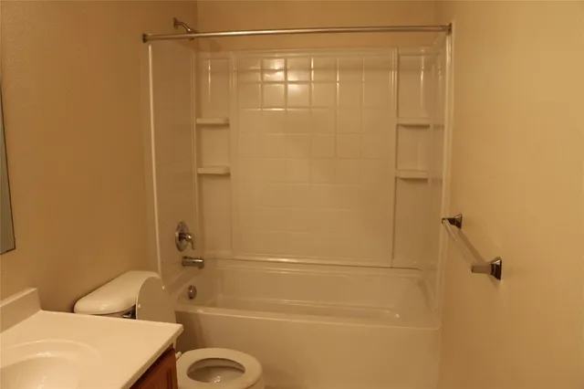 an empty room with a window and a chandelier fan