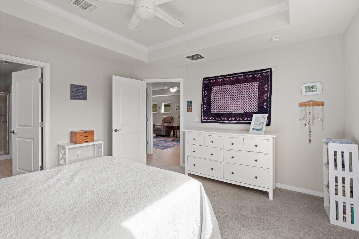 512 Rockport Street Georgetown, TX 78633 - Photo 15 of 26 a bedroom with a bed and a dresser in it