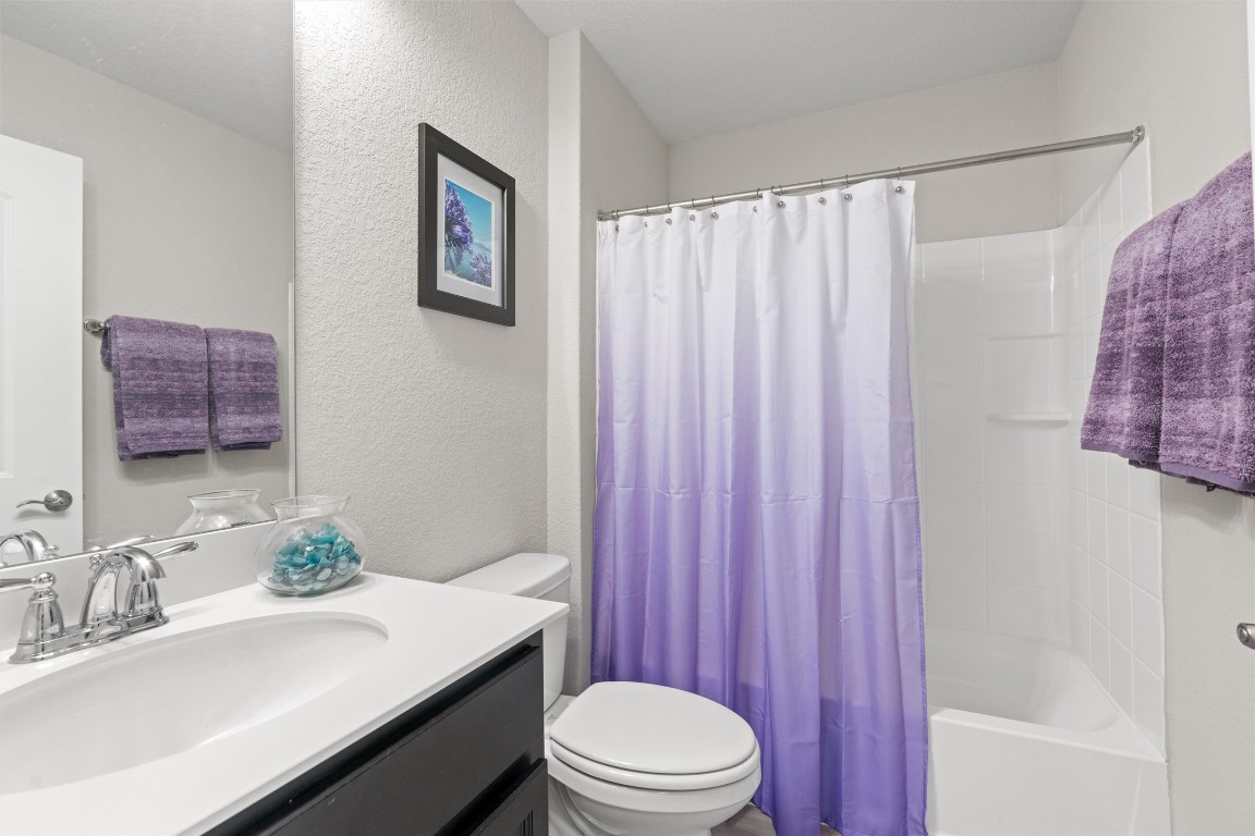 512 Rockport Street Georgetown, TX 78633 - Photo 21 of 26 a bathroom with a sink a toilet and shower curtain