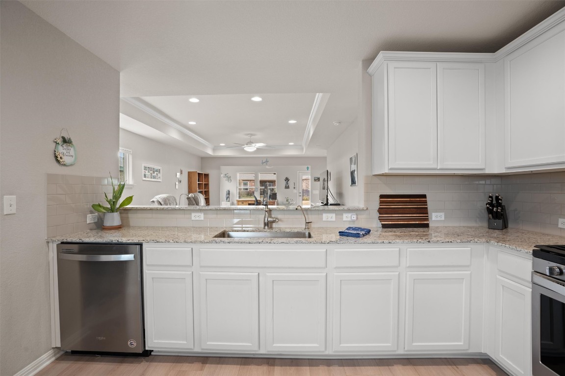 512 Rockport Street Georgetown, TX 78633 - Photo 6 of 26 a kitchen with stainless steel appliances granite countertop a sink and a white cabinets