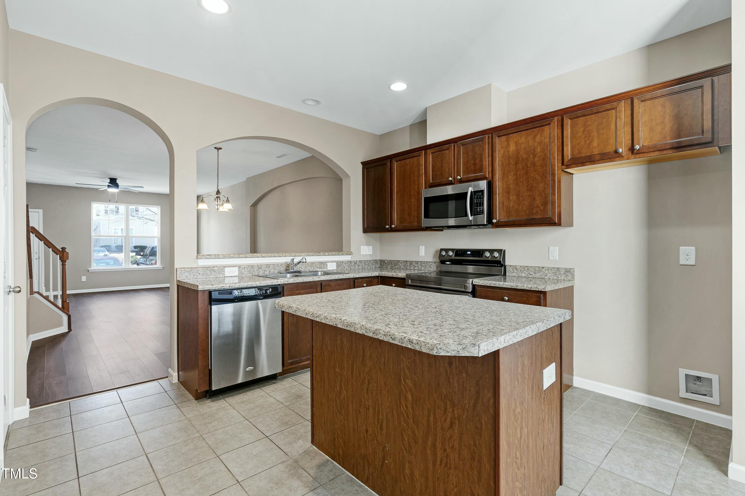 2972 Berkeley Springs Place Raleigh, NC 27616 - Photo 2 of 21 a kitchen with stainless steel appliances granite countertop a stove a sink and a microwave