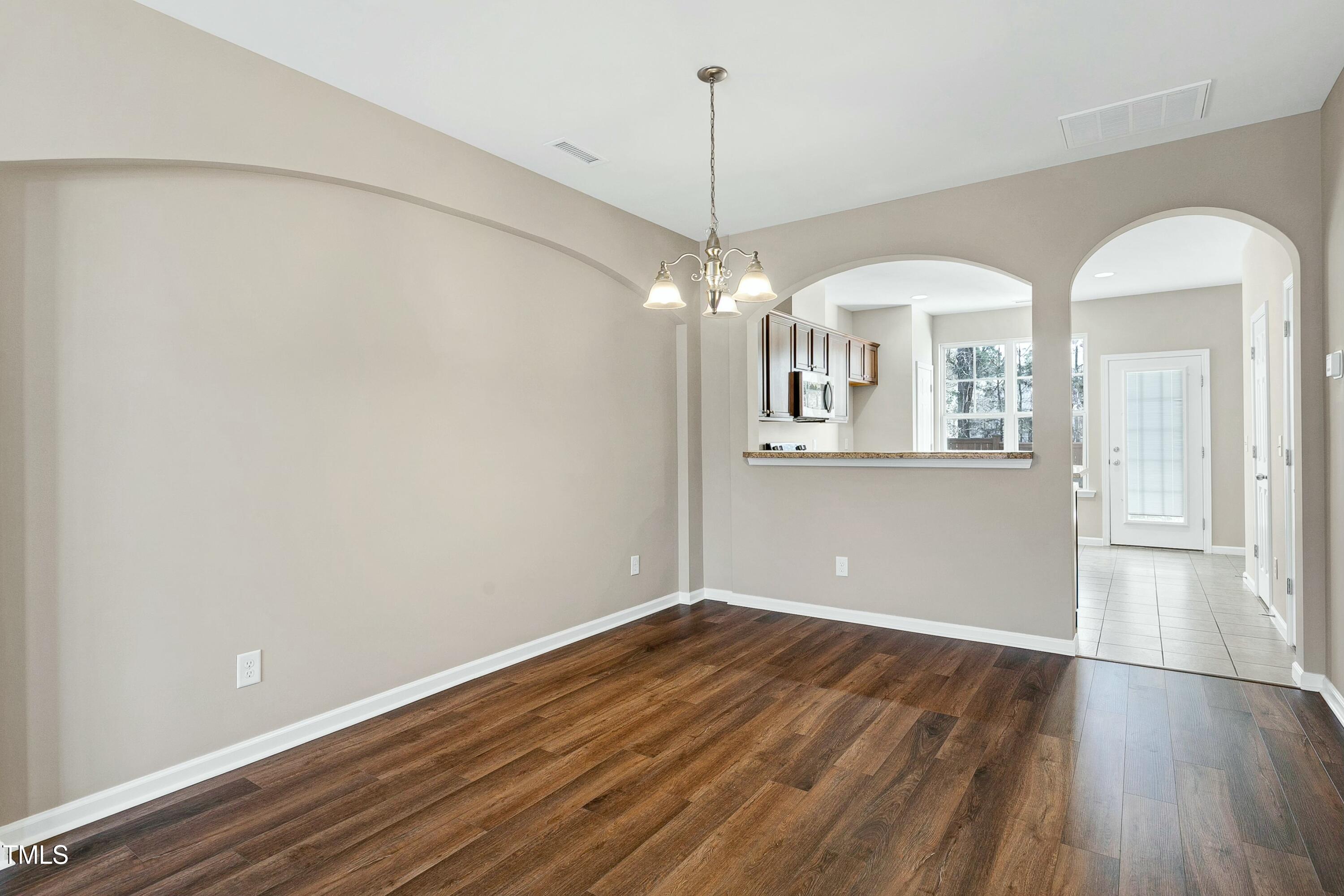 2972 Berkeley Springs Place Raleigh, NC 27616 - Photo 7 of 21 a view of a room with wooden floor and chandelier