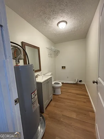 a bathroom with a toilet sink and mirror