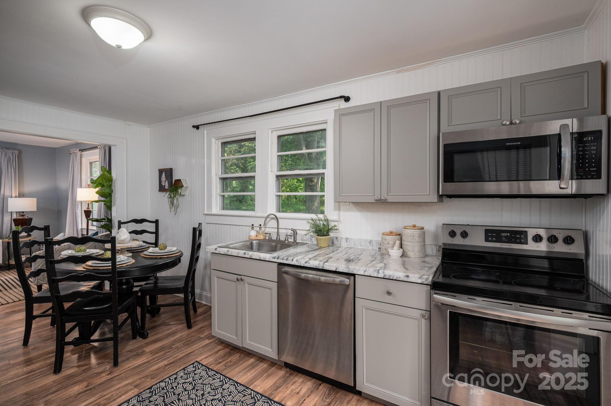 143 Hallman Street Cherryville, NC 28021 - Photo 14 of 31 a kitchen with stainless steel appliances kitchen island granite countertop a sink and cabinets