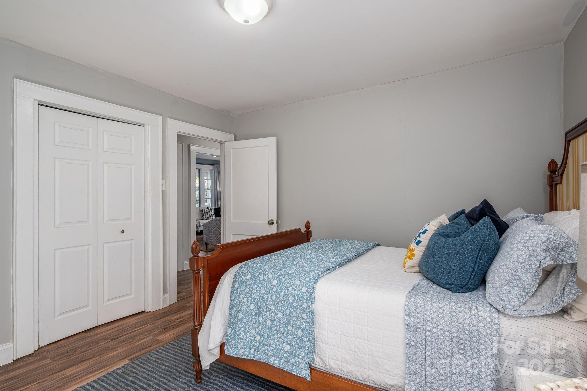 143 Hallman Street Cherryville, NC 28021 - Photo 20 of 31 a bedroom with a bed and wooden floor