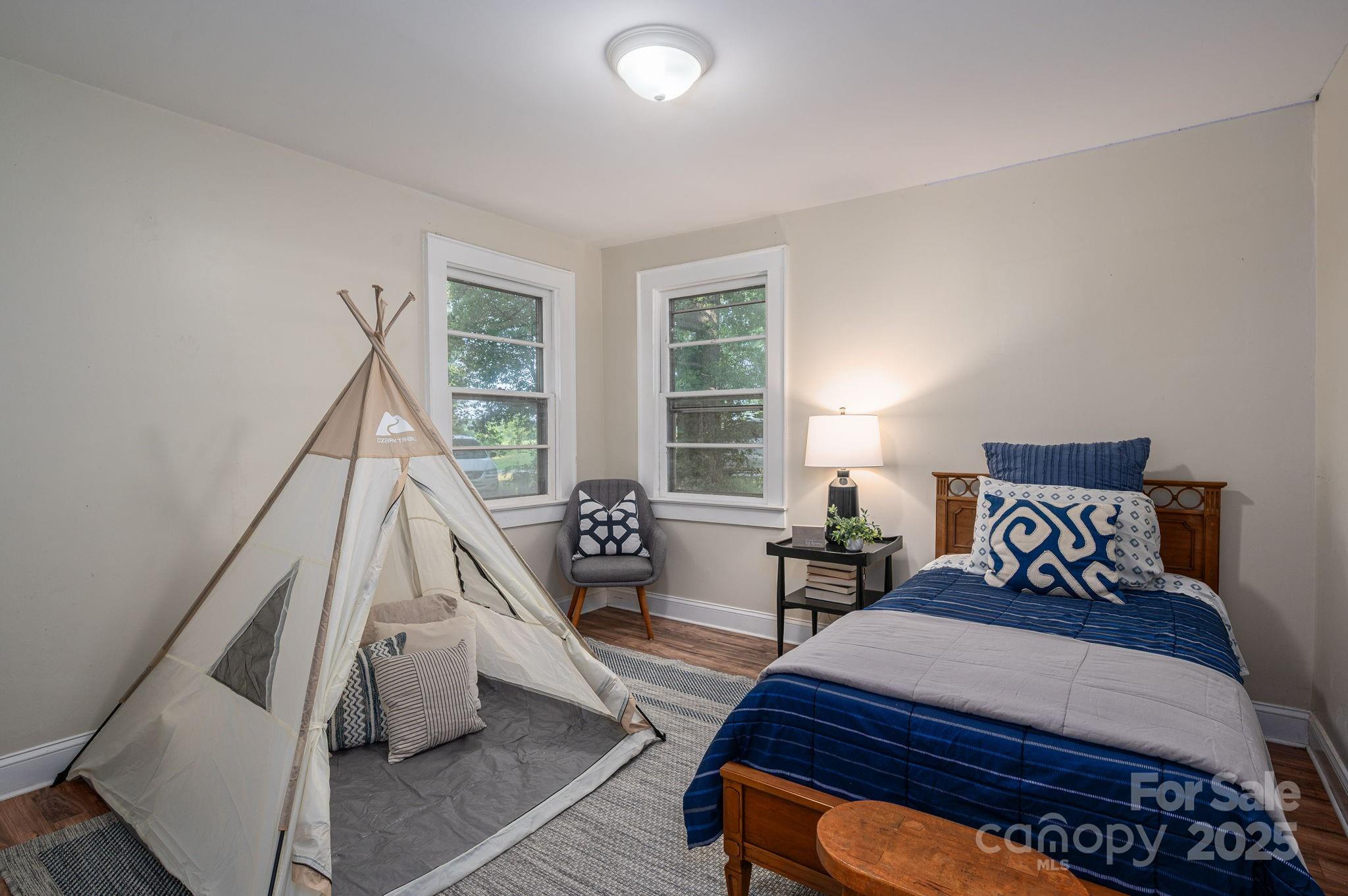 143 Hallman Street Cherryville, NC 28021 - Photo 21 of 31 a bedroom with a bed and wooden floor