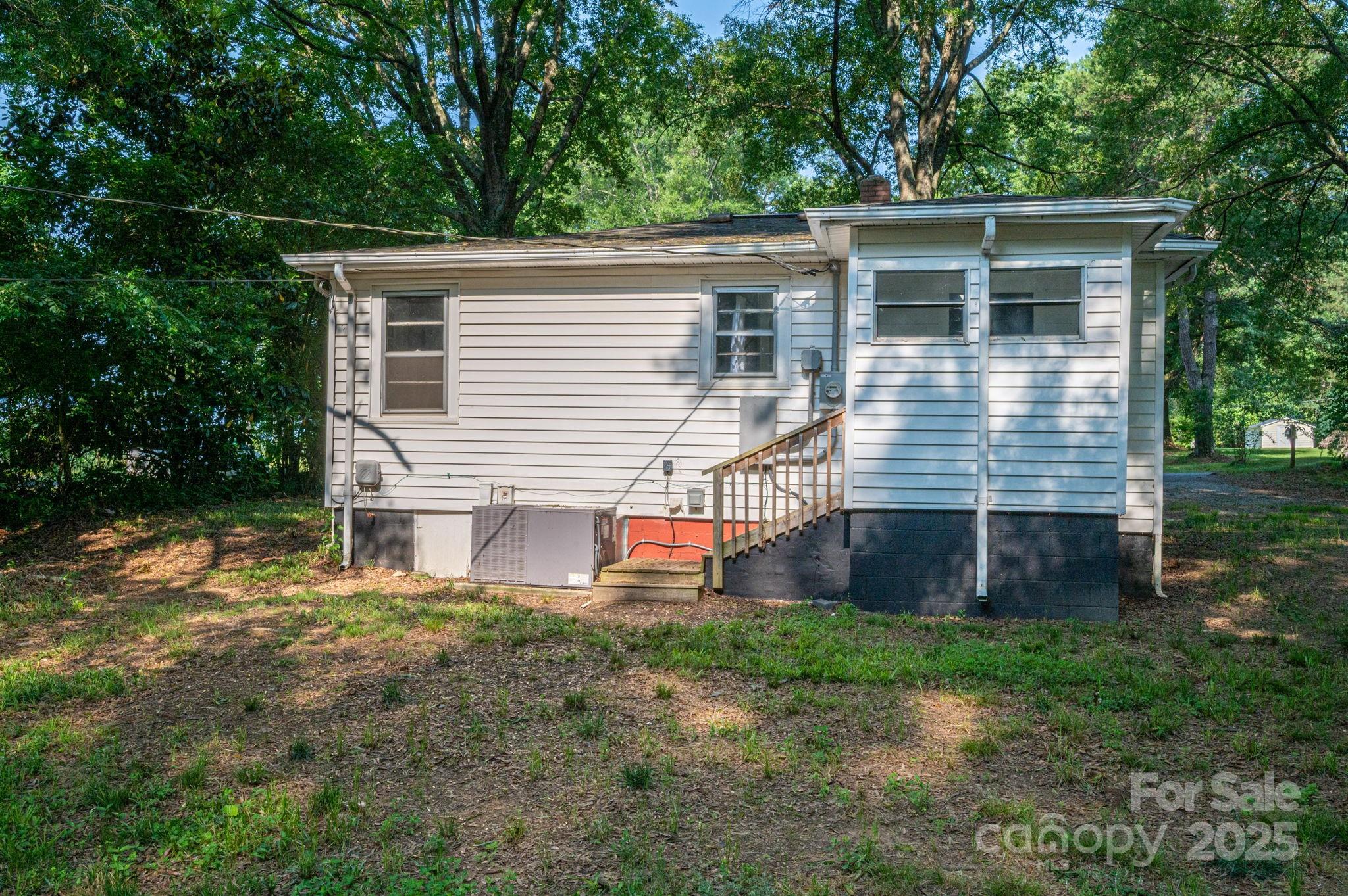 143 Hallman Street Cherryville, NC 28021 - Photo 28 of 31 a front view of house with yard and trees in the background