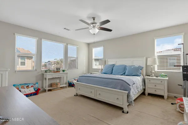 a spacious bedroom with a bed and a window