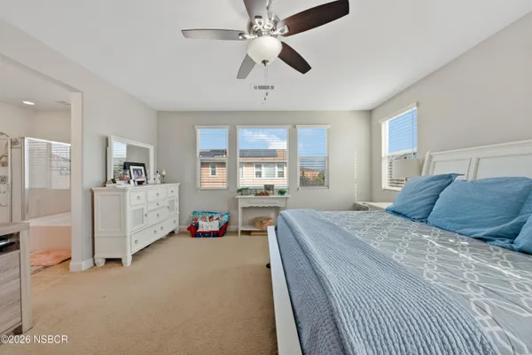 a spacious bedroom with a bed and a walk in closet