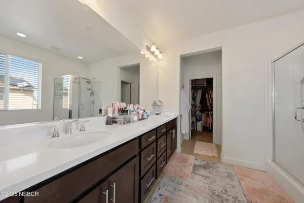 a spacious bathroom with a double vanity sink a and a mirror