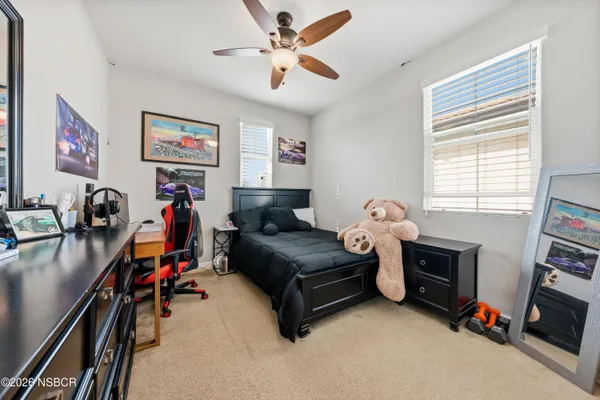 a living room with furniture a window and a flat screen tv