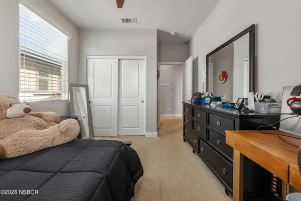 a bedroom with a bed and a closet