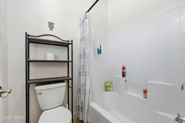 a bathroom with a toilet and a bathtub