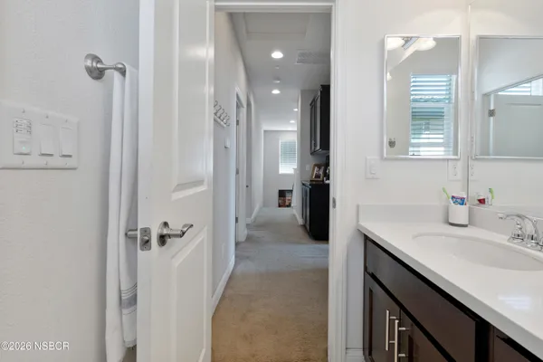 a bathroom with a sink vanity granite tub and shower