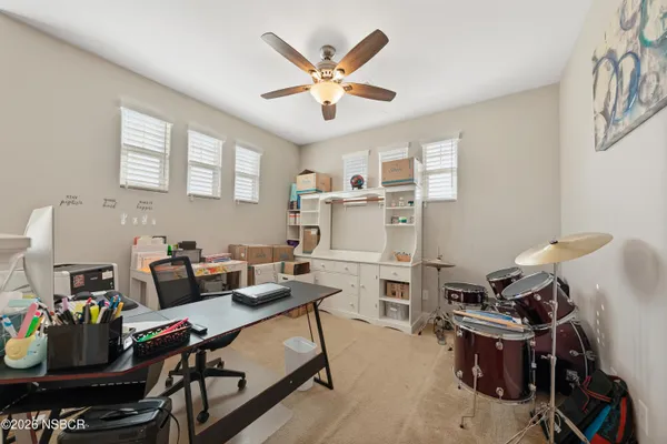 a work room with furniture and white walls