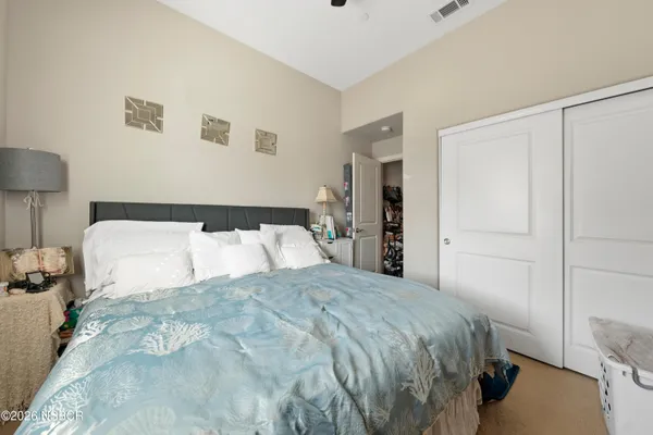 a bedroom with a bed and a lamp