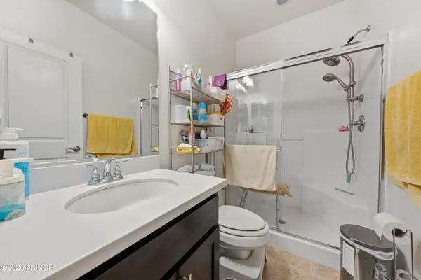 a bathroom with a sink toilet and shower