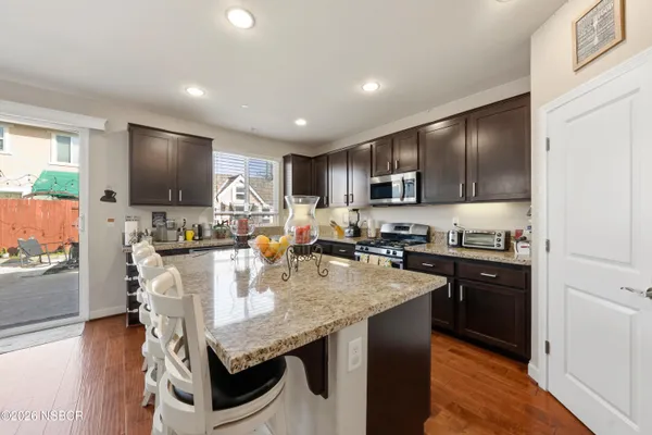 a kitchen with a table chairs stove and refrigerator