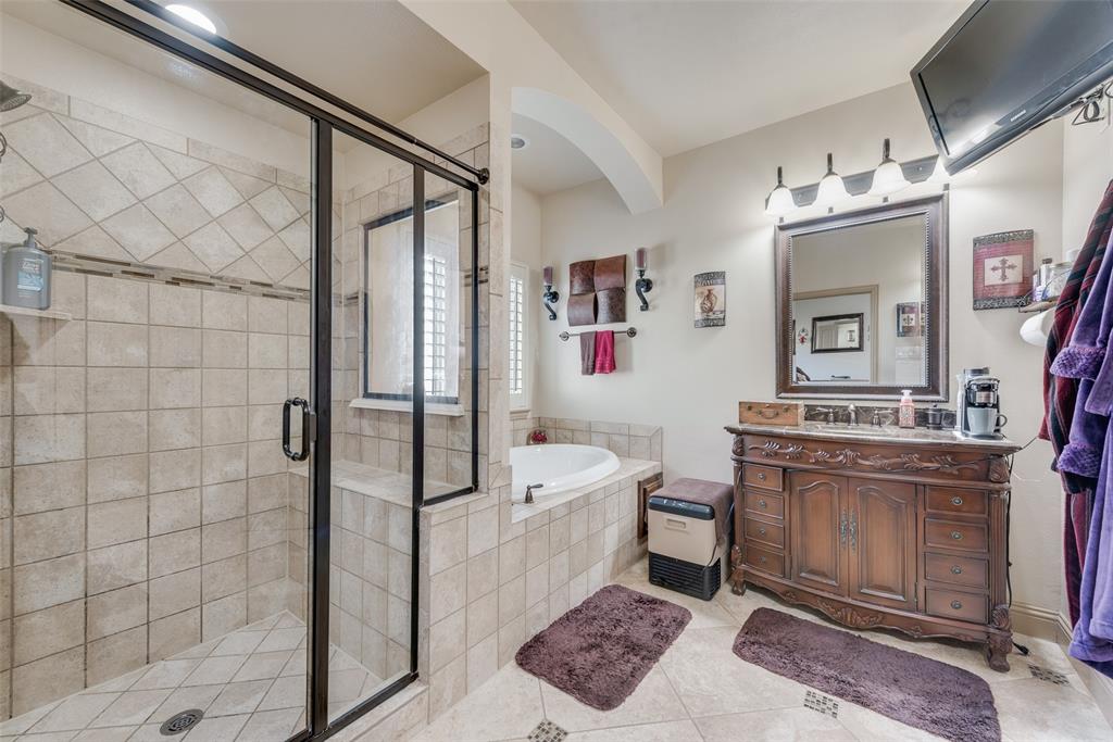 5056 Empire Way Irving, TX 75038 - Photo 20 of 39 Main Primary Bathroom featuring vanity, shower with separate bathtub, and tile patterned flooring