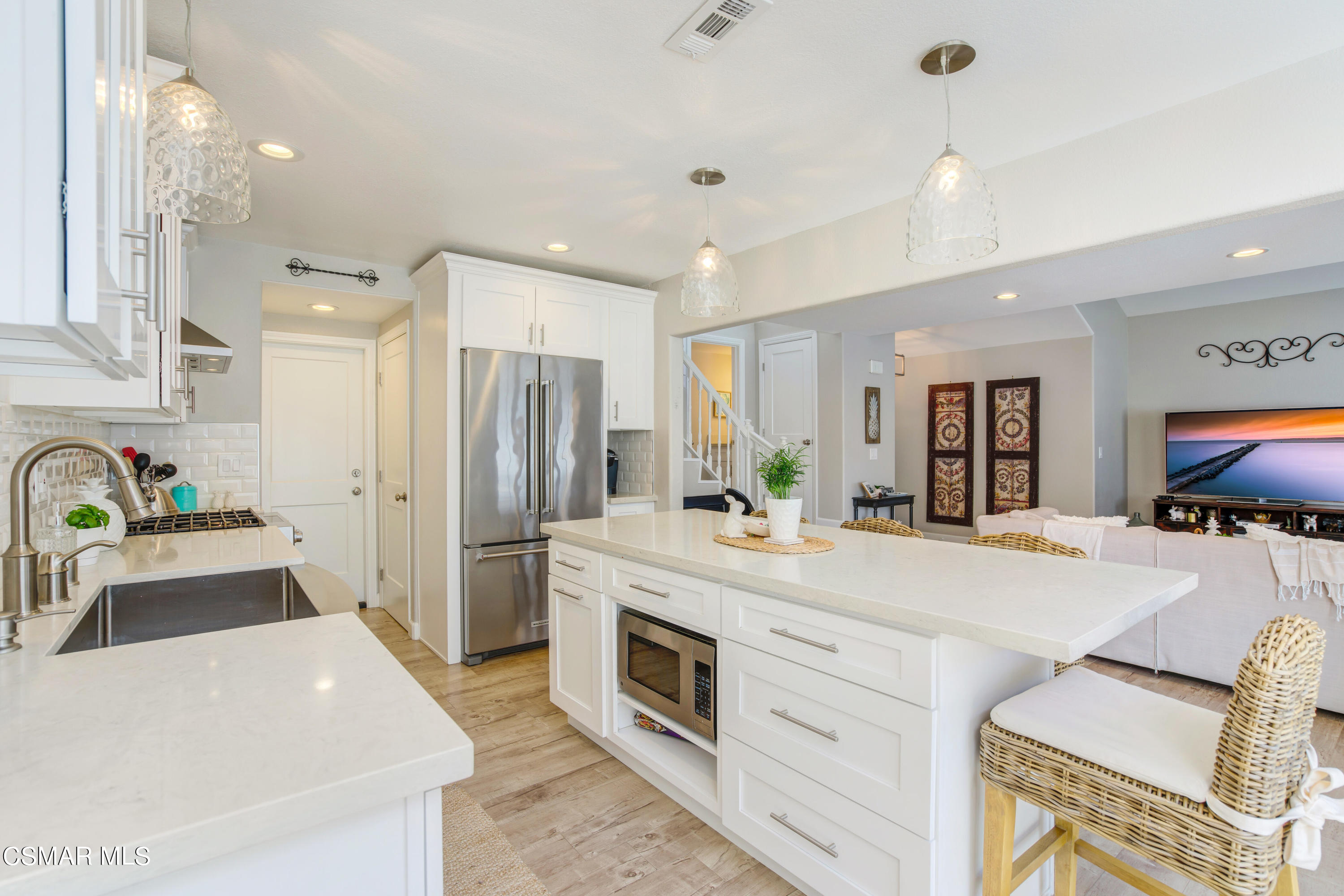 1948 Rory Lane, Unit 4 Simi Valley, CA 93063 - Photo 11 of 23 a large kitchen with stainless steel appliances a center island cabinets and a refrigerator