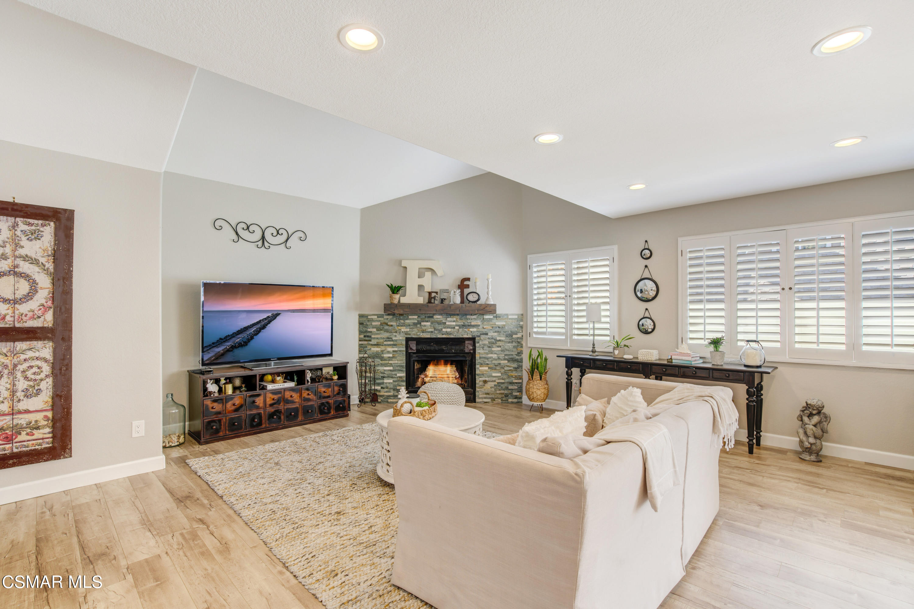 1948 Rory Lane, Unit 4 Simi Valley, CA 93063 - Photo 4 of 23 a living room with furniture a fireplace and a flat screen tv