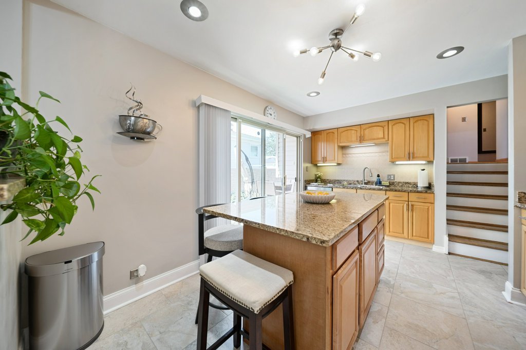 365 West Myrick Avenue Addison, IL 60101 - Photo 9 of 49 a kitchen with a table chairs refrigerator and a sink