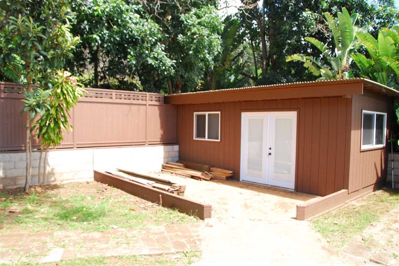 745 Lower Kimo Drive, Unit A Kula, HI 96790 - Photo 7 of 16 a backyard of a house with large trees and outdoor seating