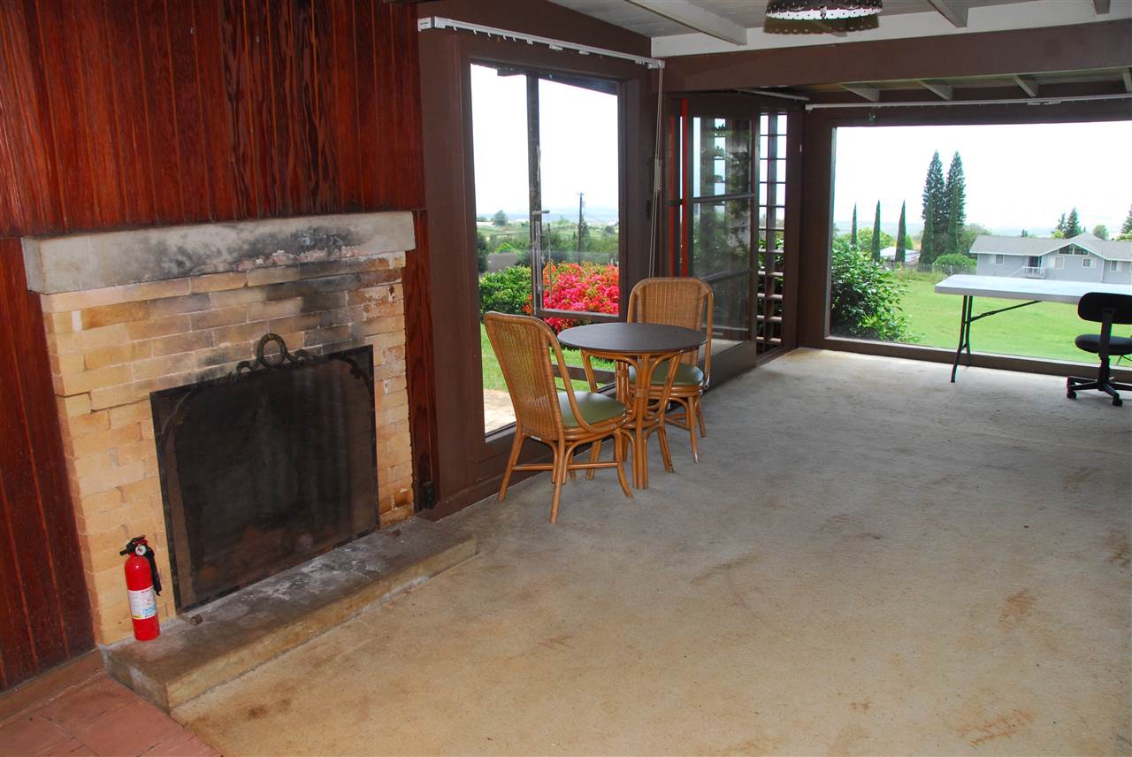 745 Lower Kimo Drive, Unit A Kula, HI 96790 - Photo 10 of 16 a living room with a fireplace furniture and a floor to ceiling window