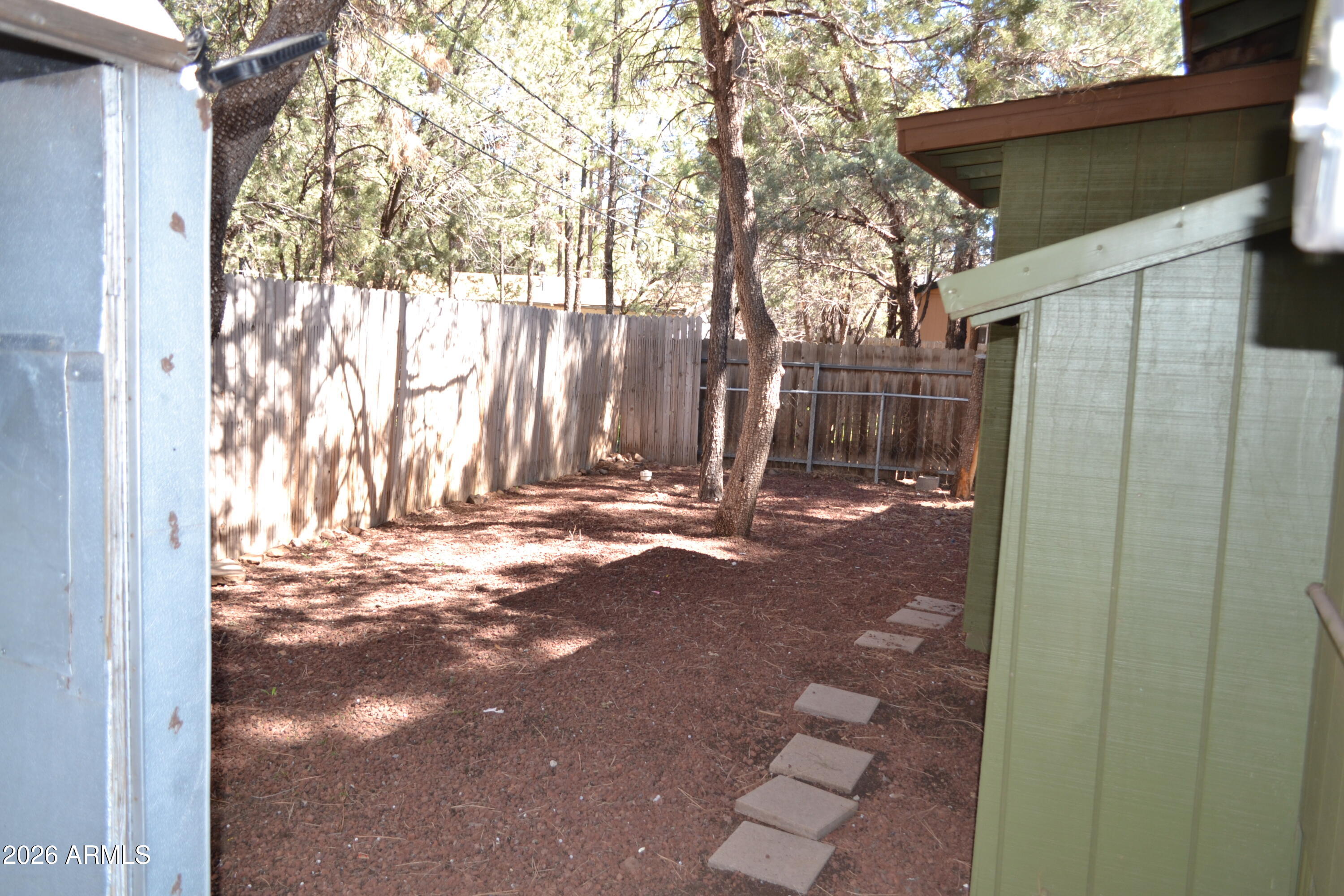 5994 D Street Lakeside, AZ 85929 - Photo 17 of 21 a backyard of a house with trees and outdoor space