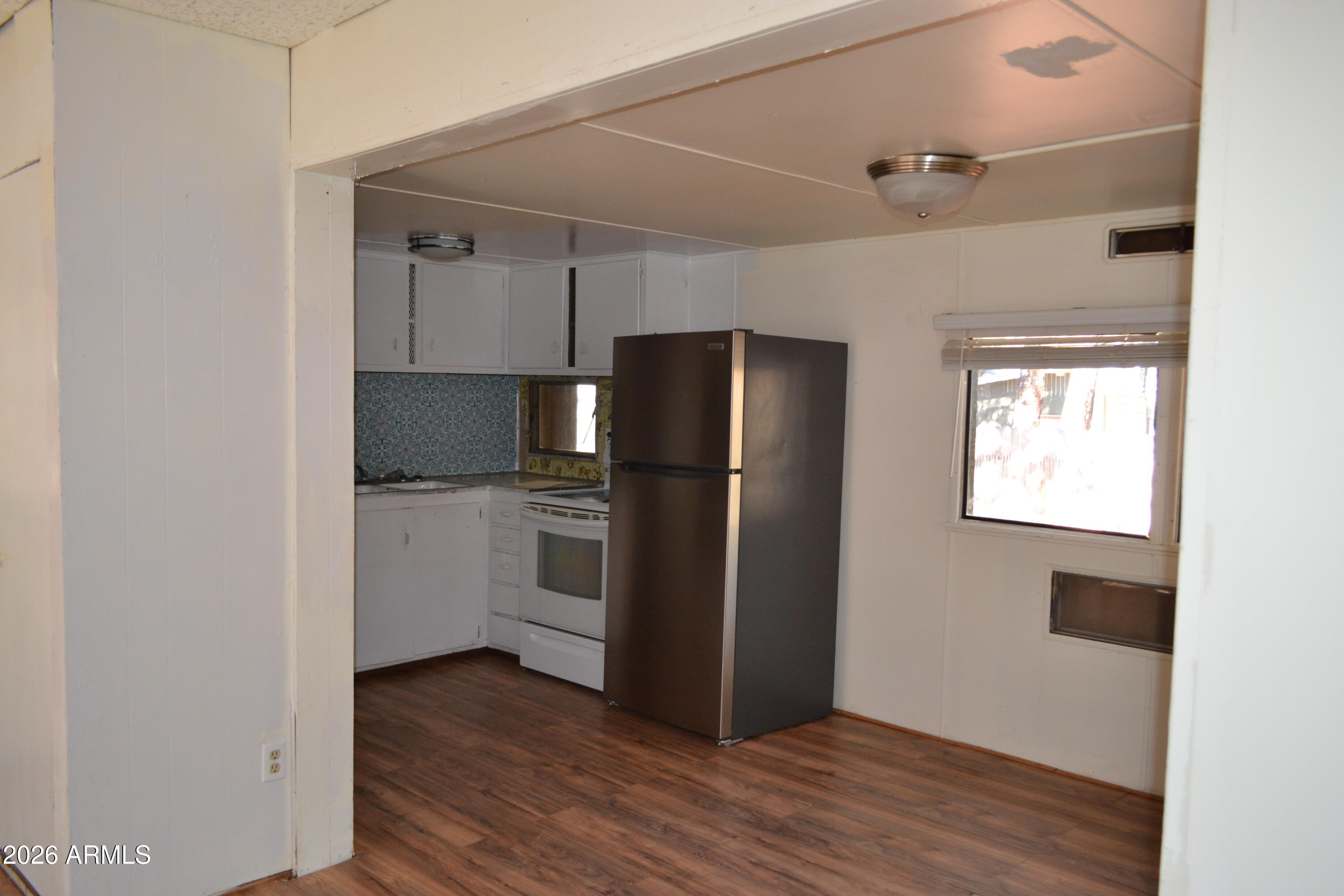 5994 D Street Lakeside, AZ 85929 - Photo 5 of 21 a kitchen with a refrigerator cabinet and a sink