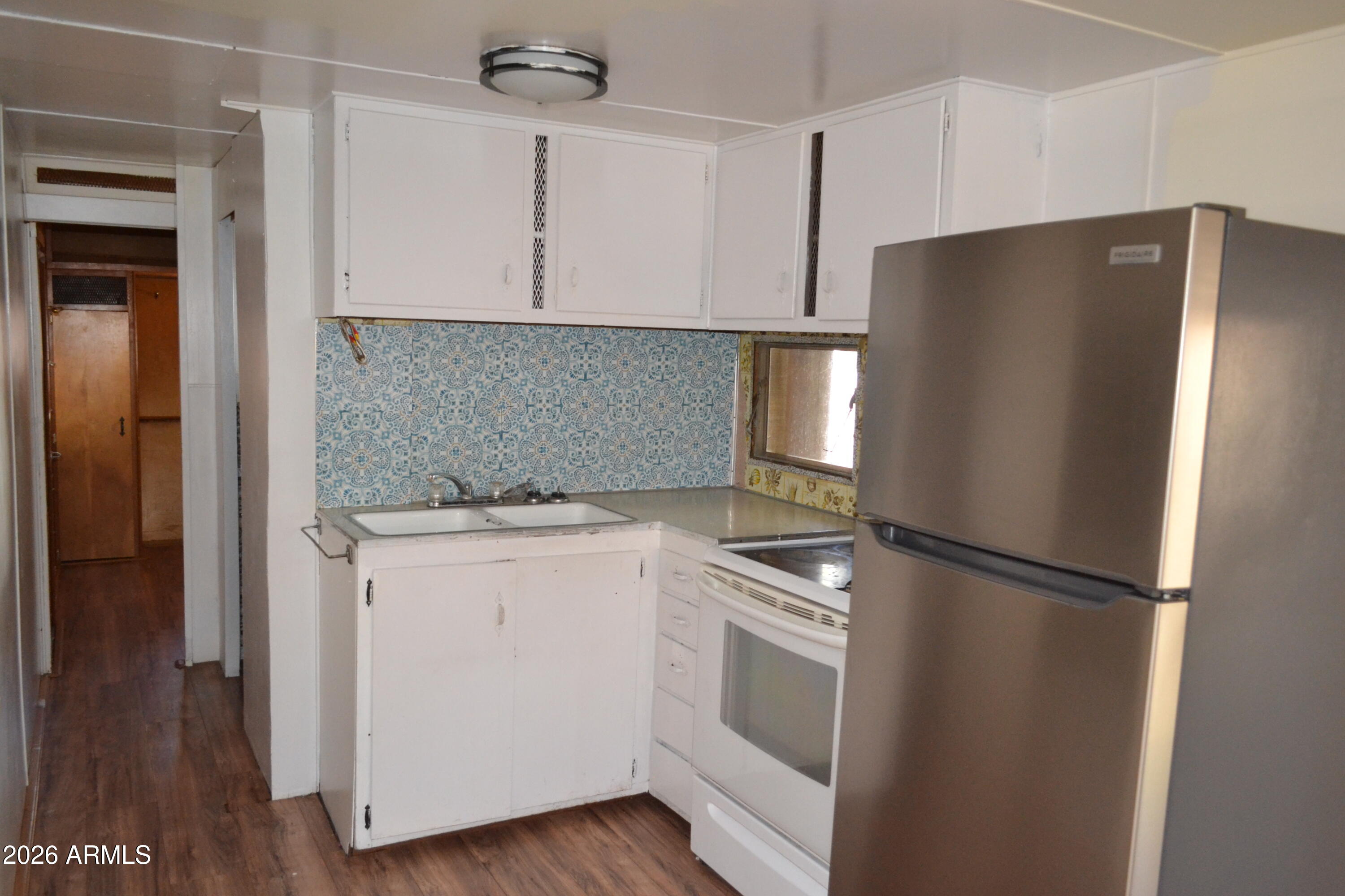 5994 D Street Lakeside, AZ 85929 - Photo 8 of 21 a kitchen with a refrigerator sink and cabinets