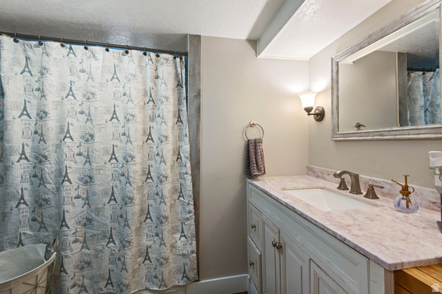 255 North 1600 West, Unit 60 Provo, UT 84601 - Photo 11 of 22 Full bath with vanity, a textured ceiling, and a shower with curtain